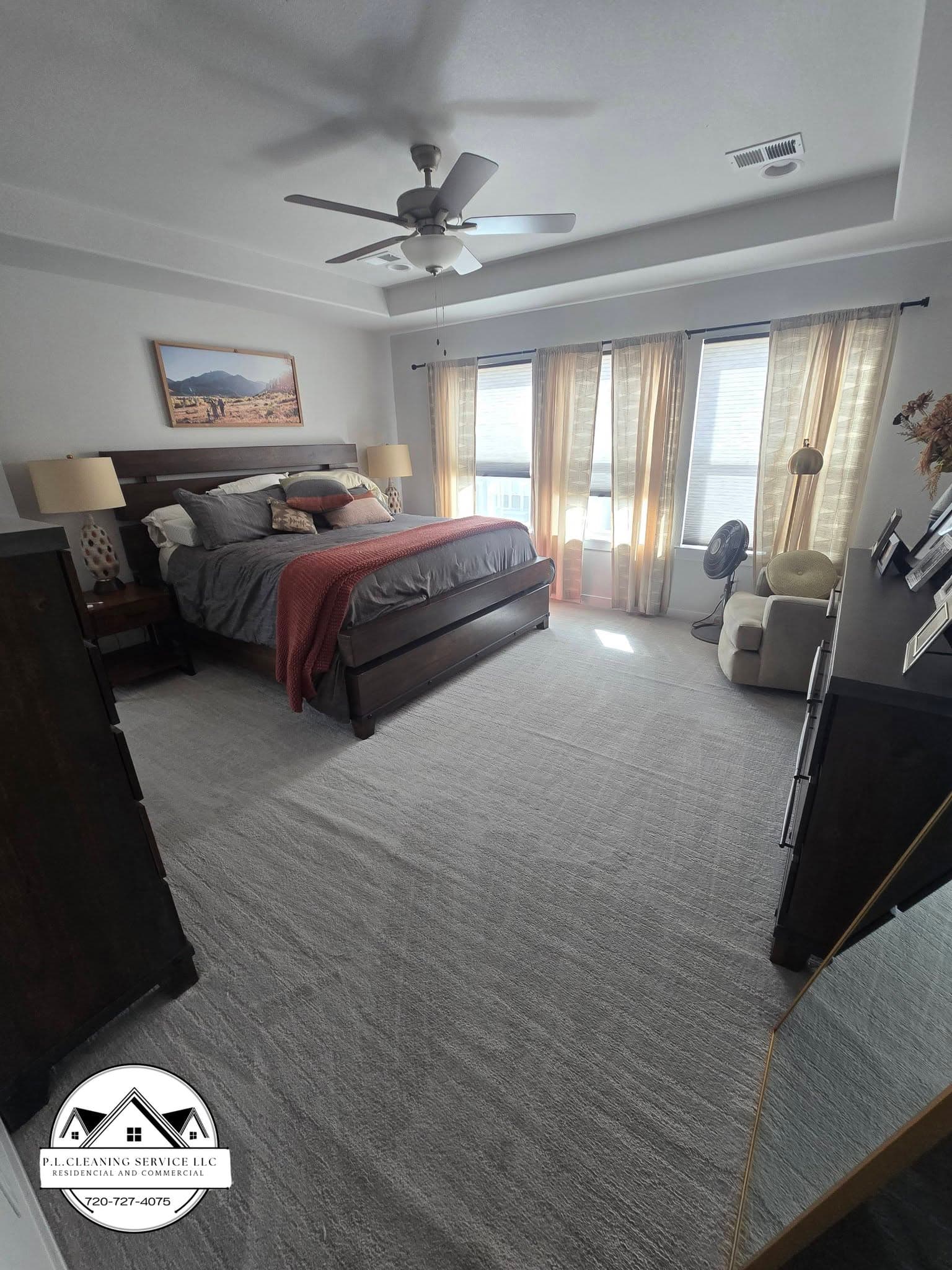 Spacious master bedroom with carpeted flooring