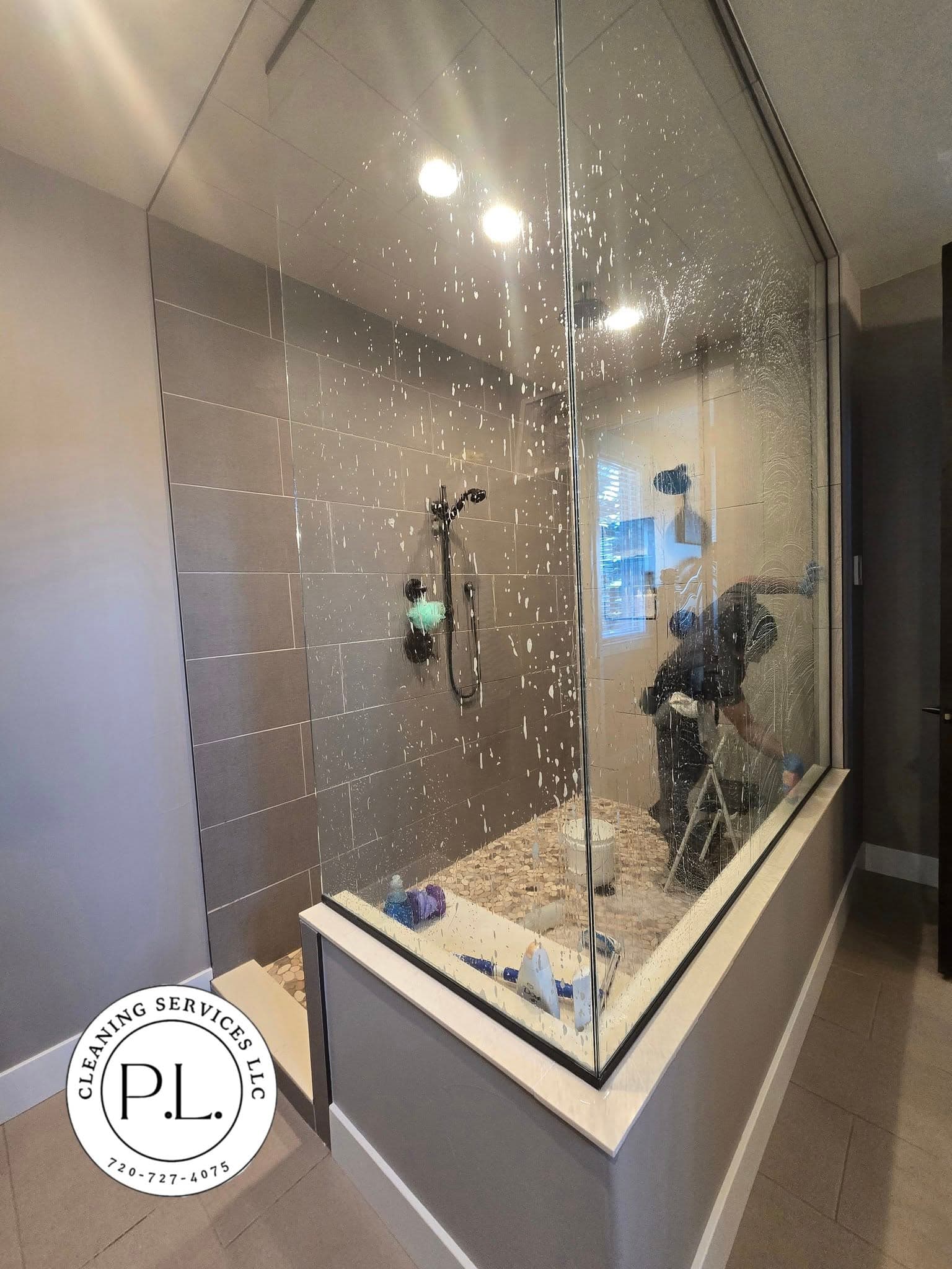 Glass-enclosed shower enclosure