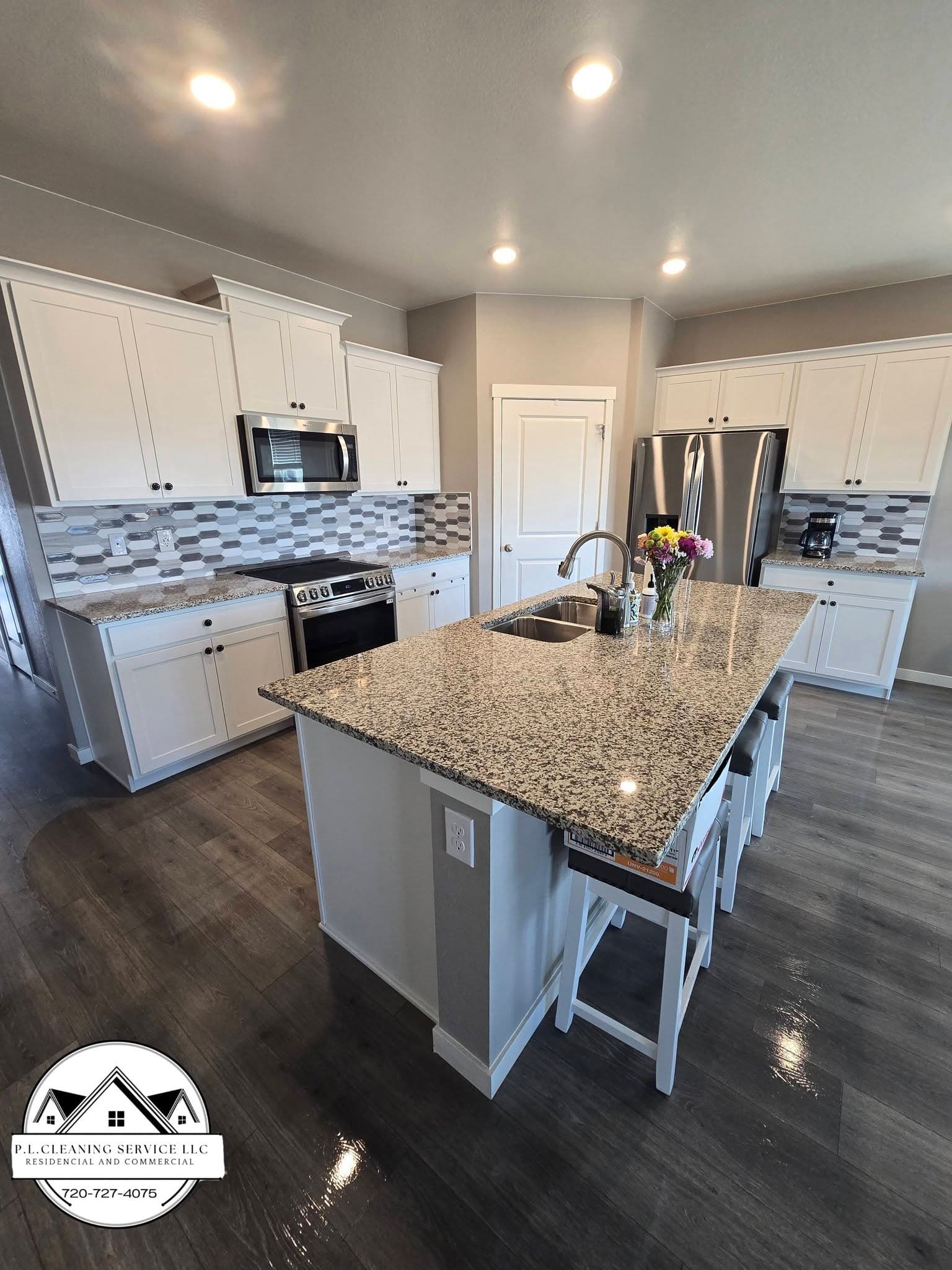 Kitchen with white island and pendant lighting